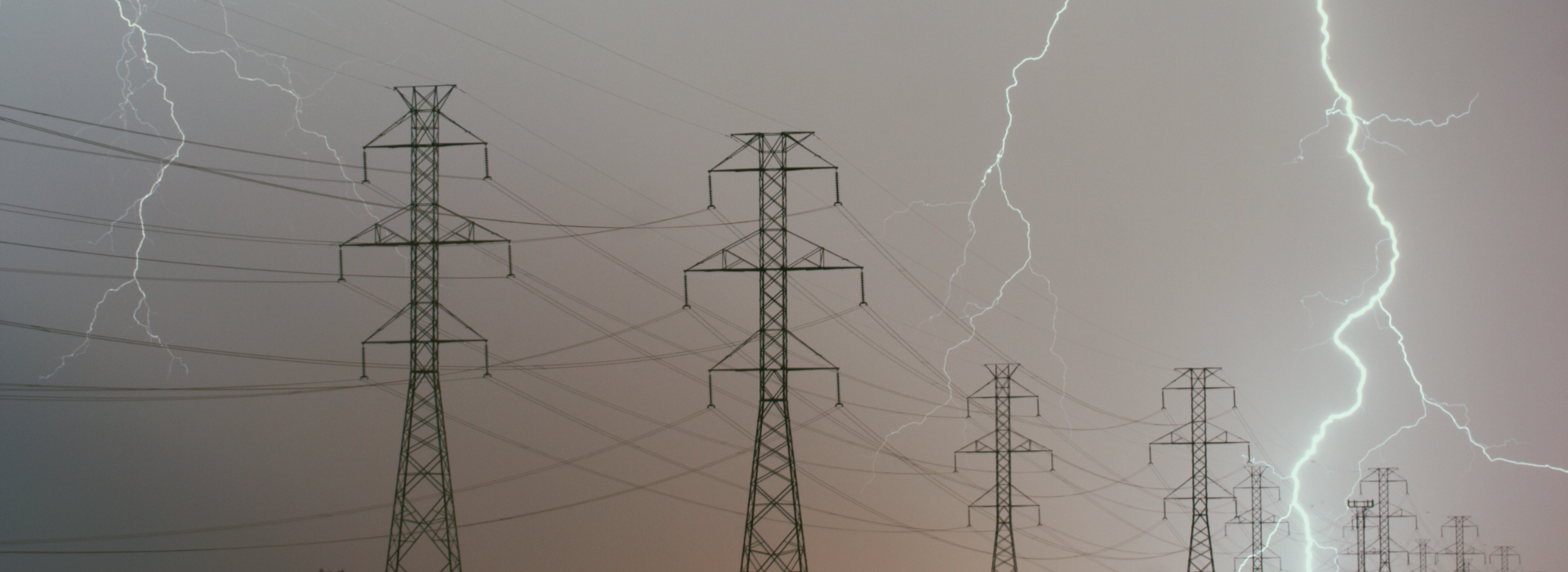 Lightning striking near electrical transmission poles.